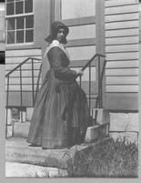SA0125 - Portrait of an unidentified woman on steps to a building; perhaps from the New Lebanon, NY Shaker community., Winterthur Shaker Photograph and Post Card Collection 1851 to 1921c